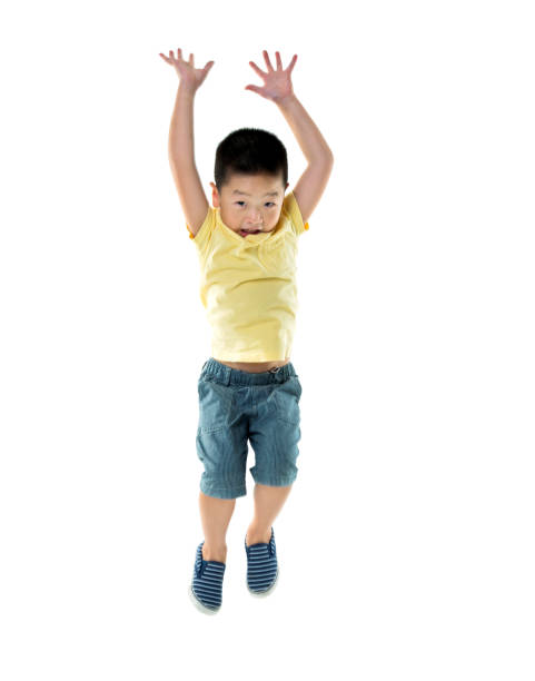 istock Young boy jumping against white background 1192310707