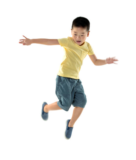 istock Young boy jumping against white background 1192310979