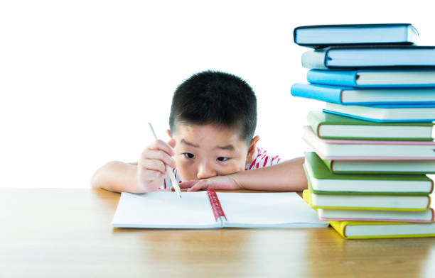 istock Asian boy with books against white background 1192311033