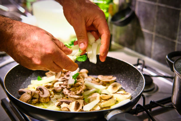 istock Man prepares fried onion and other vegetables 1192313383