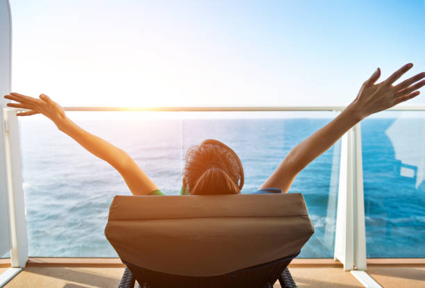 Cheering woman open arms on cruise.