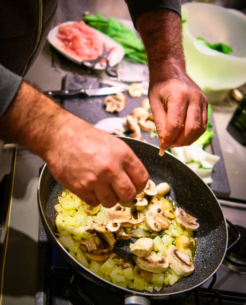 istock Man prepares fried onion and other vegetables 1192313526