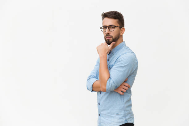 istock Serious pensive guy touching chin 1192313631