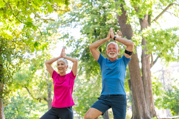 istock Active Senior Couple is Stretching Outdoors in Nature 1192314999