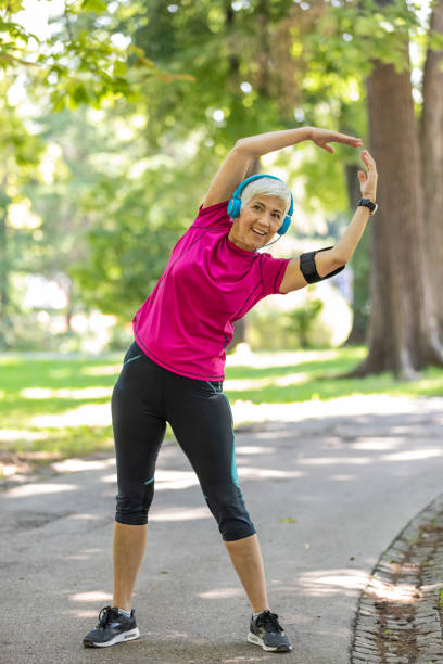 istock Senior Woman is Doing Warm Up Exercise in Nature 1192315864