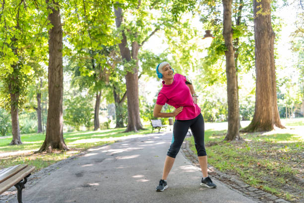 istock Senior Woman is Doing Warm Up Exercise in Nature 1192316302