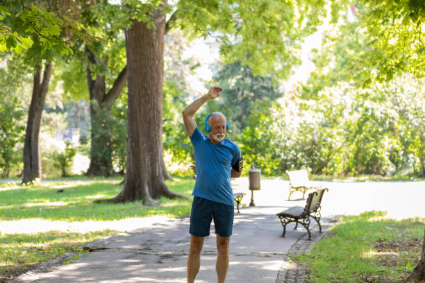 istock Mature Man is Doing Warm Up Exercise in the Nature 1192316385