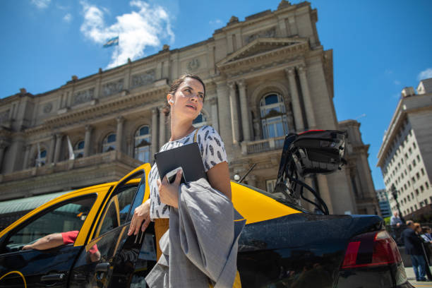 hermosa mujer de negocios hispana saliendo del taxi - taxi buenos aires people city fotografías e imágenes de stock