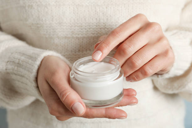 Woman holding jar of moisturizing cream, closeup. Winter cosmetic. Space for text Woman holding jar of moisturizing cream, closeup. Winter cosmetic. Space for text ointment photos stock pictures, royalty-free photos & images