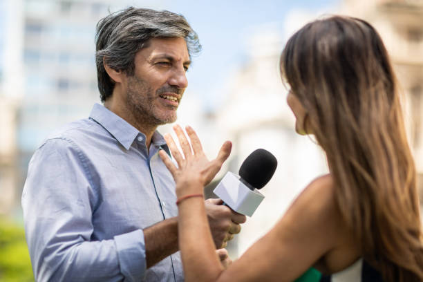 istock Woman interviewed  by journalist 1192317208