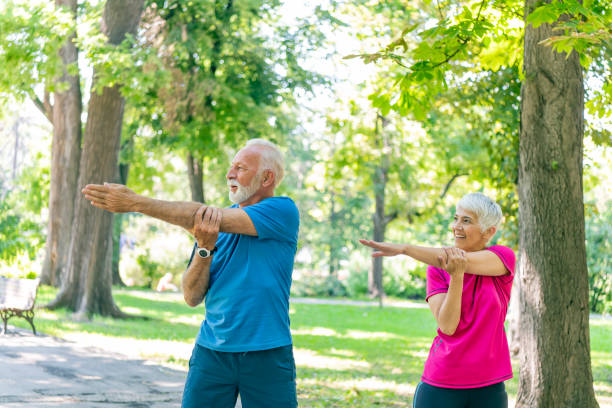 istock Active Senior Couple is Stretching Outdoors in Nature 1192317239