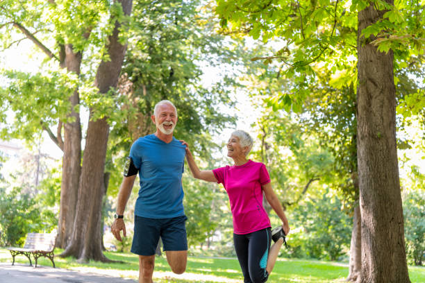 istock Mature Couple is Doing Warm-up Exercise in Public Park 1192317272