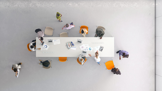 Overhead view of a group of people working in the office. All elements in the scene are 3D