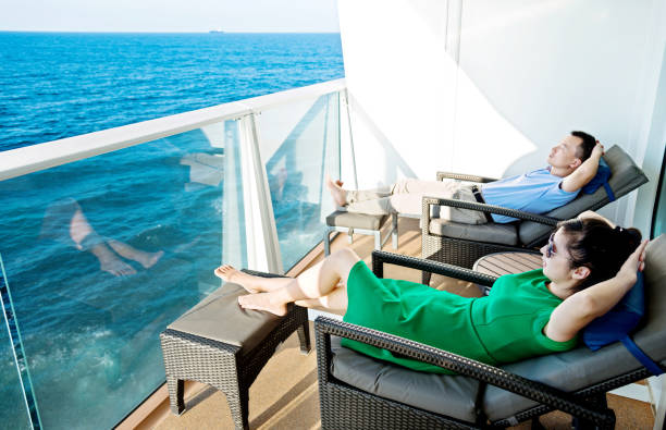 junges paar entspannt auf balkon mit malerischem meerblick auf einem kreuzfahrtschiff - vacations luxury balcony heterosexual couple stock-fotos und bilder