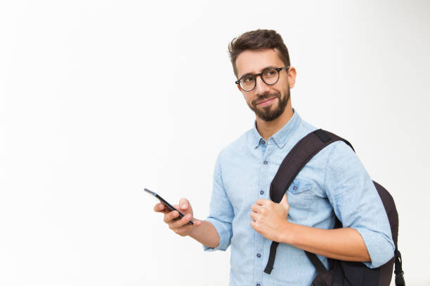 istock Positive male tourist with backpack using mobile phone 1192318524