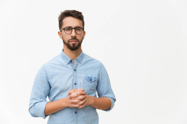 istock Front of serious confident man with clasped hands 1192319028