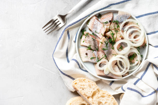 istock Pieces of pickled herring with onions 1192322694