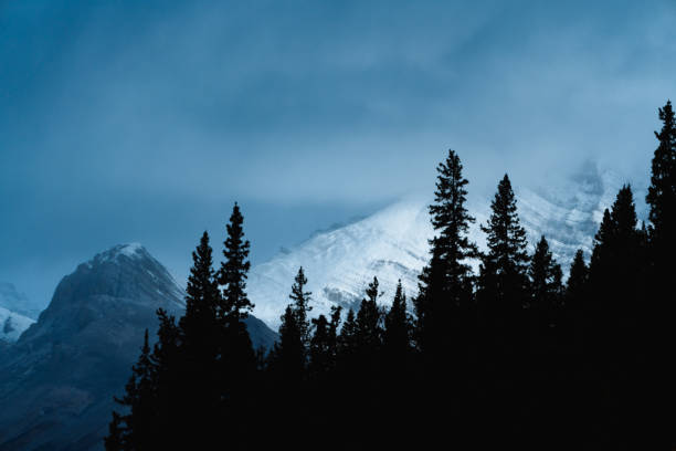 istock Dramatic light with silhouette of mountains 1192323936