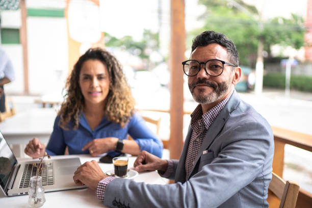 istock Portrait of colleagues working in a cafeteria 1192327806