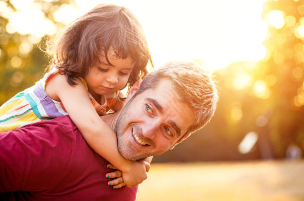 istock Happy father playing with his daughter in park. 1192328617