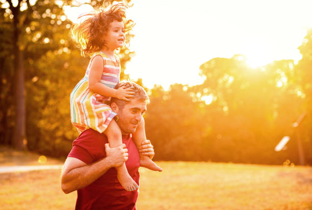 istock Happy father playing with his daughter in park. 1192328631