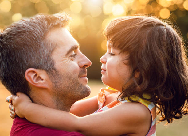 istock Happy father playing with his daughter in park. 1192328689
