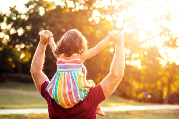 istock Happy father playing with his daughter in park. 1192328747