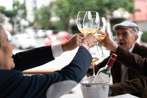 istock Senior friends toasting wine in restaurant 1192330159