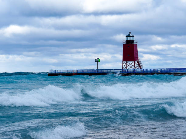 Lake Michigan Lighthouse, Charlevoix Stormy winter waves crash around a Lake Michigan Lighthouse charlevoix photos stock pictures, royalty-free photos & images