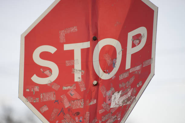 istock Old dirty bent road stop sign close-up. 1192333189