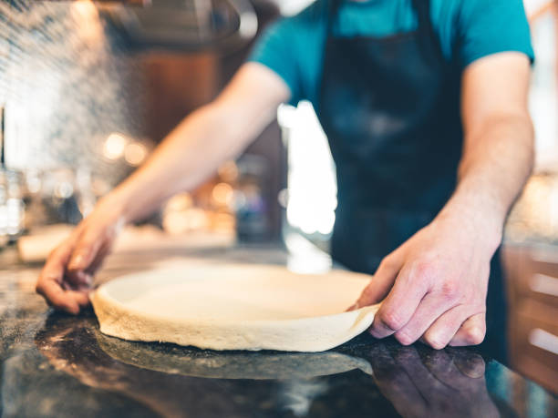 istock Hands of Man making pizza 1192334365