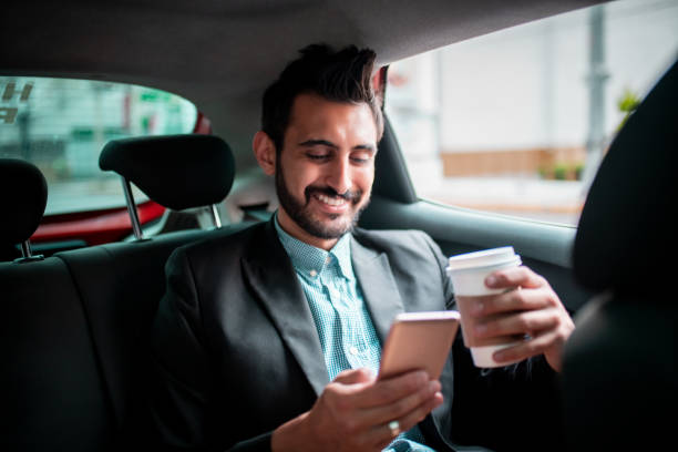 istock Happy businessman in car using phone 1192334566
