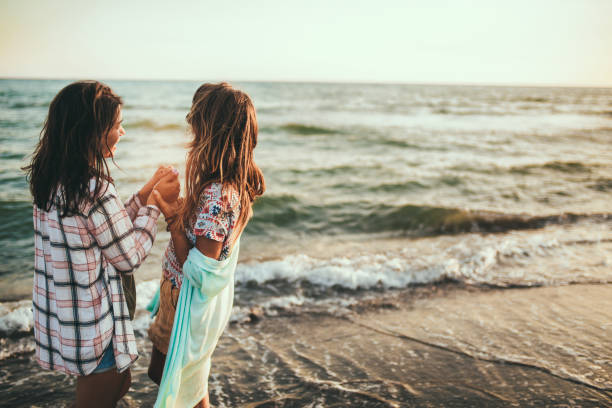 istock Pretty girl has a fun with her girlfriend on the beach 1192334596