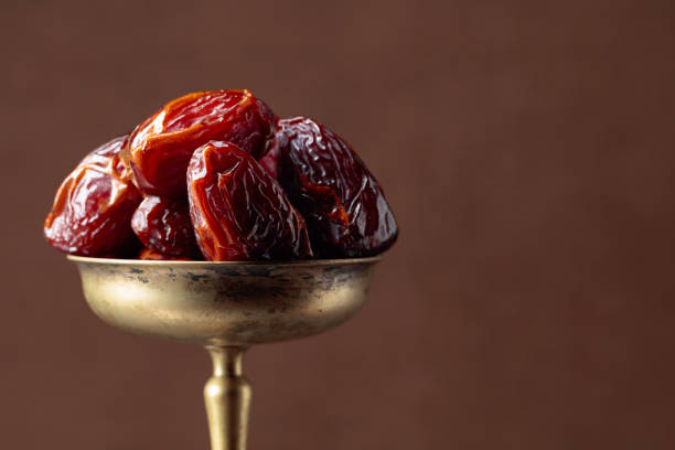 istock Closeup sweet dried dates in brass dish. 1192334615