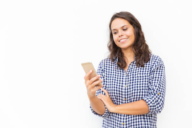 istock Cheerful positive Latin woman with smartphone reading message 1192334653
