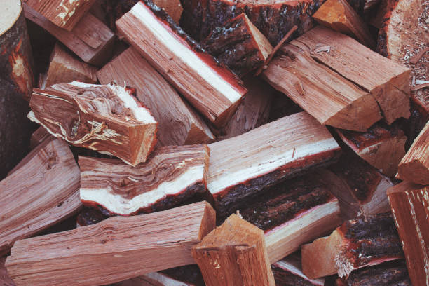 istock pile of split logs for fire, tinted image 1192335957
