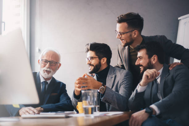istock Business executive talking with three male employees. 1192341196