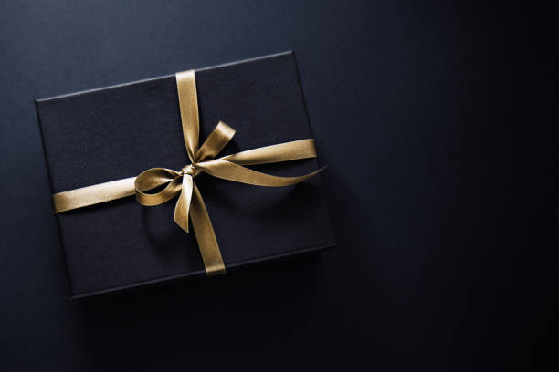 istock Gift wrapped in dark paper on dark background 1192341452