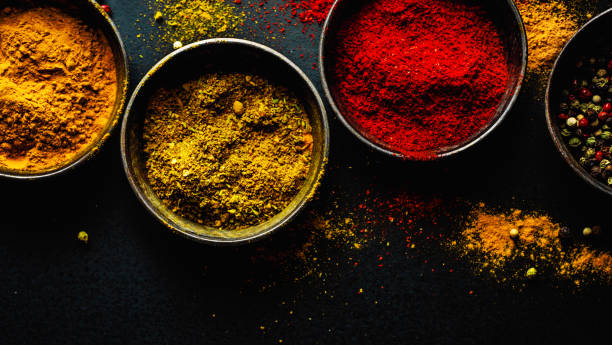 istock Colorful spices on dark background 1192341636