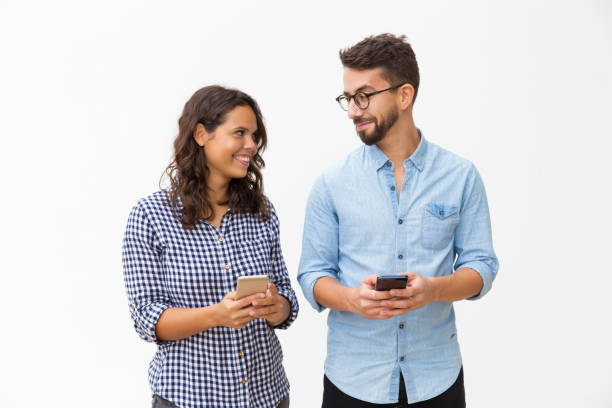 istock Cheerful couple using cellphones 1192342516