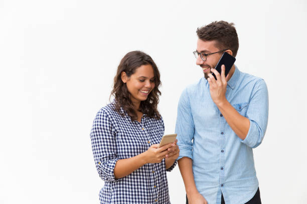 istock Happy cheerful couple calling on mobile phones 1192342588