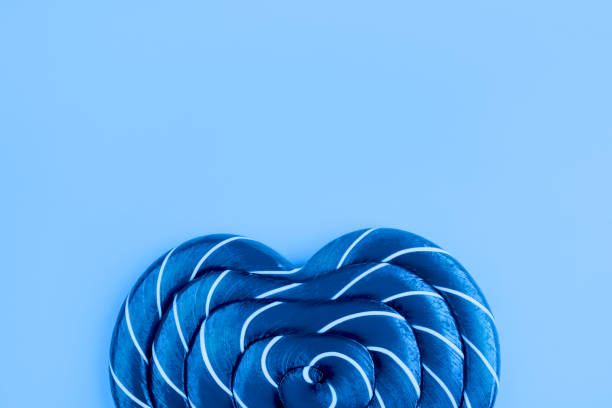 Lollipop on blue background. Trendy color of year.
