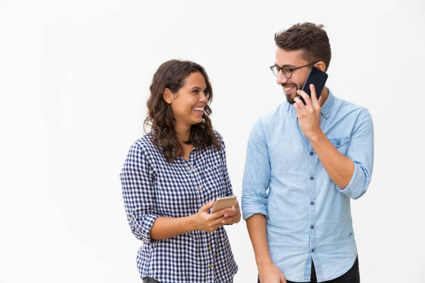 istock Happy joyful couple using mobile phones 1192343526