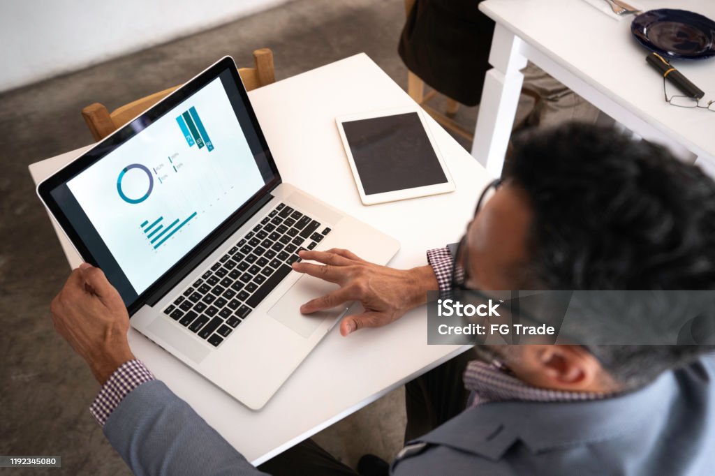 High angle view of a businessman using laptop in a restaurant Computer Monitor Stock Photo