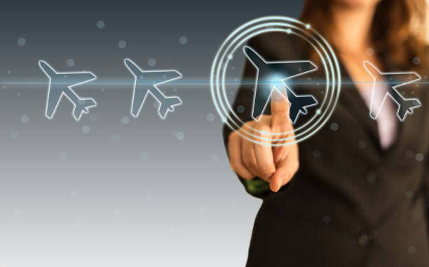 istock Businesswoman select a flight by touch screen airplane button 1192345160