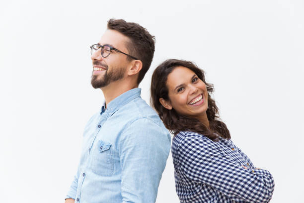 istock Joyful couple standing back-to-back and laughing 1192345217