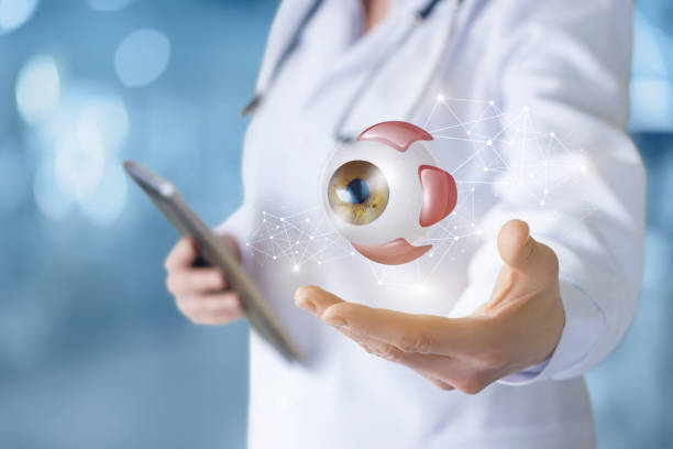 Doctor in hand shows eye . Doctor in hand shows eye on blurred background. cornea photos stock pictures, royalty-free photos & images