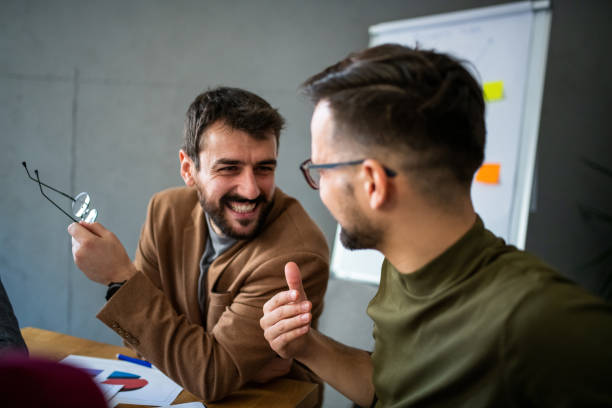 istock Two cheerful entrepreneurs talking in office. 1192346504