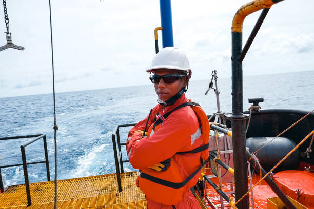 istock Offshore engineer, standing on the deck of an industrial ship 1192346941