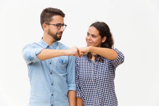 satisfied couple making fist bump gesture - made man object imagens e fotografias de stock